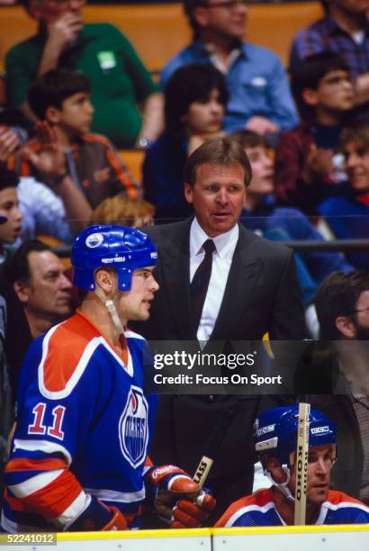 Endmonton Oilers coach Glen Sather observes the game from the bench.