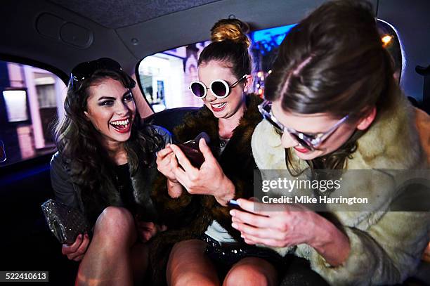 women laughing together in taxi - friends women makeup stockfoto's en -beelden
