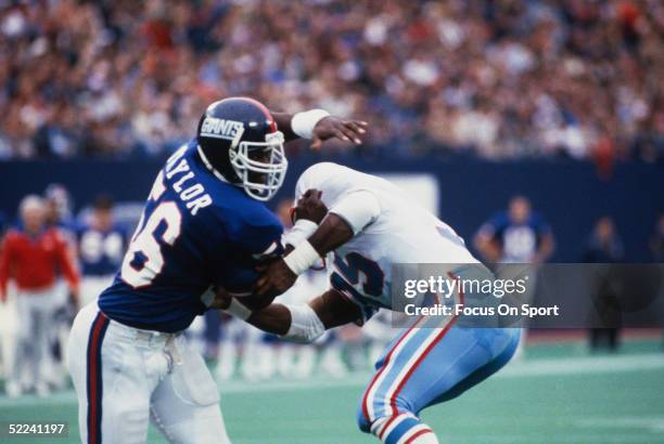 Lawrence Taylor of the New York Giants pass rushes against the Houston Oilers during a circa 1980s game at Giants Stadium in East Rutherford, New...