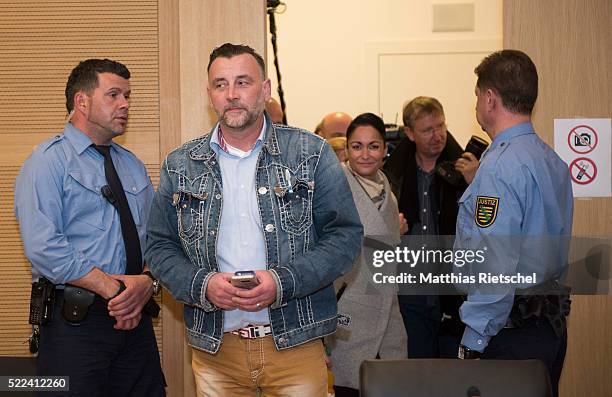 Lutz Bachmann, left, founder of the Pegida movement, his wife Vicky, behind, arrive to the courtroom after a break on the first day of his trial to...