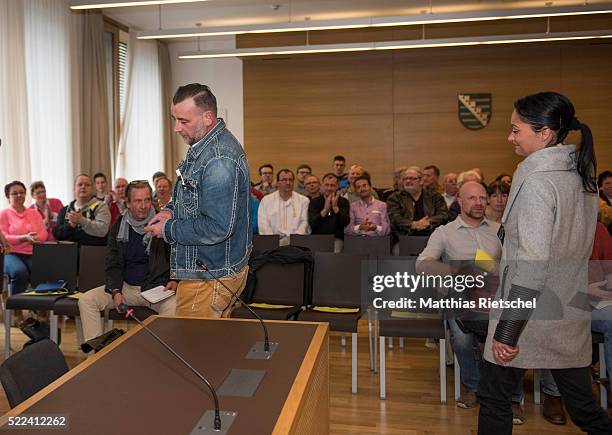 Lutz Bachmann, left, founder of the Pegida movement, his wife Vicky, right, arrive to the courtroom after a break on the first day of his trial to...