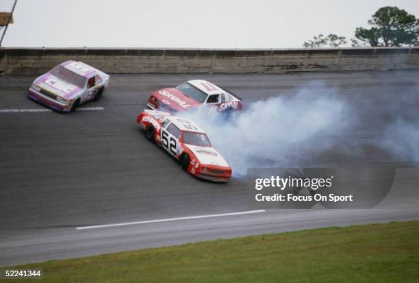 The Red Barron car spins out of control on a turn as two cars swerve to avoid the wreck during the Daytona 500 at the Daytona Speedway on Febuary 19,...