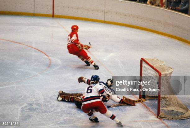 Aleksandr Maltsev of the USSR scores against Jim Craig and Bill Baker of Team USA during the XIII Olympic Winter Games on February 22, 1980 in in...