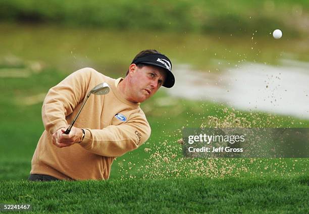 Phil Mickelson of the USA hits a bunker shot to the 15th green during his second round match of the Accenture Match Play Championship against Angel...