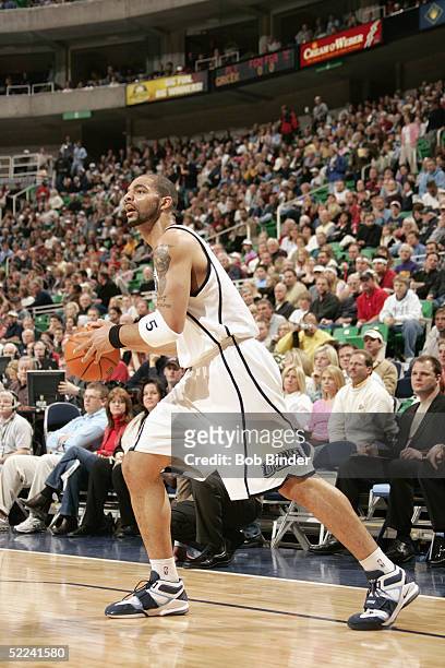 Carlos Boozer of the Utah Jazz controls the ball against the Minnesota Timberwolves during the game on February 11, 2005 at the Delta Center in Salt...