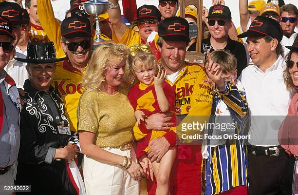 Sterling Marlin holds up his kid and stands next to his wife Paula after winning the Daytona 500 at the Daytona Speedway on February 20, 1994 in...