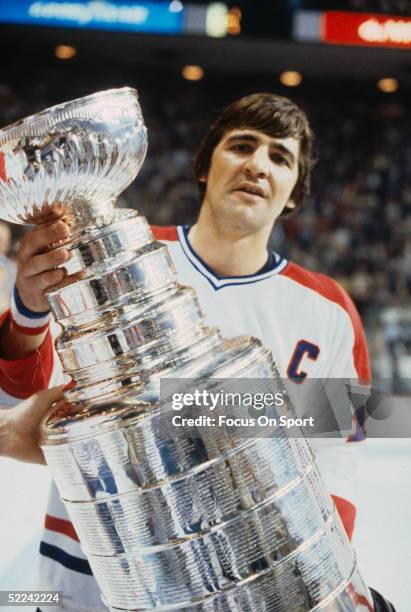 Serge Savard of the Montreal Canadiens holds the Stanley Cup Trophy after defeating the New York Rangers in Game 5 of the Stanley Cup Finals on May...