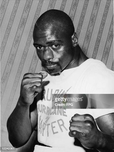 Portrait of American middleweight boxer Rubin 'Hurricane' Carter in a fighter's pose at Butcher's Arms, his training headquarters for his upcoming...