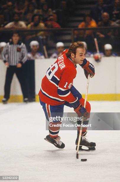 Montreal Canadiens' Guy Lafleur skates with the puck against the New York Rangers during a game at Madison Square Garden circa 1979 in New York, New...