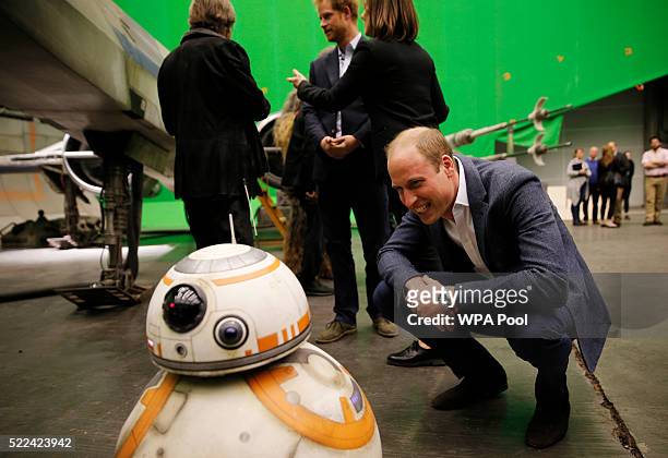 Prince William, Duke of Cambridge smiles at the BB-8 droid during a tour of the Star Wars sets at Pinewood studios on April 19, 2016 in Iver Heath,...