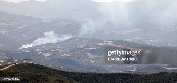 Photo taken from Yayladagi district of Turkey's Hatay province shows smoke rising after the Assad regime forces attacked at Syria's Mount Turkmen and...