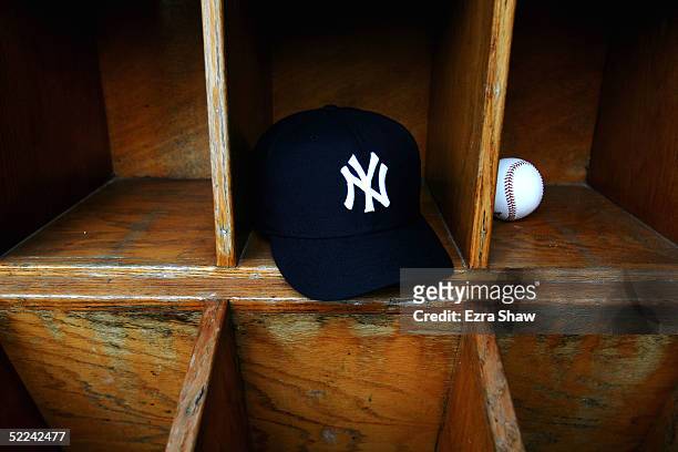 New York Yankees cap and a baseball are seen at Legends Field on February 25, 2005 in Tampa, Florida.