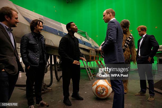 Prince William, Duke of Cambridge speaks with British actor John Boyega and Episode VIII director Rian Johnson during a tour of the Star Wars sets at...