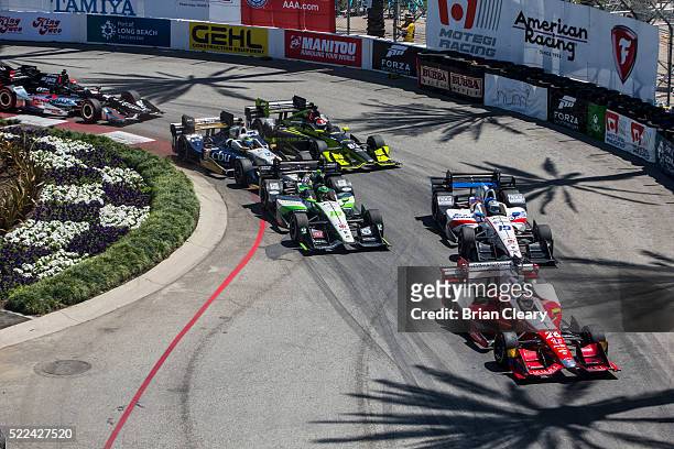 Pack of cars races through a turn at the start of the Toyota Grand Prix of Long Beach on April 17, 2016 in Long Beach, California.