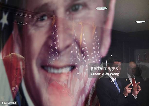 Speakers of the House Rep. Paul Ryan speaks as his reflection is seen on a portrait of former President George W. Bush during a media availability...
