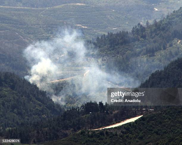Photo taken from Yayladagi district of Turkey's Hatay province shows smoke rising after the Assad regime forces attacked at Syria's Mount Turkmen and...