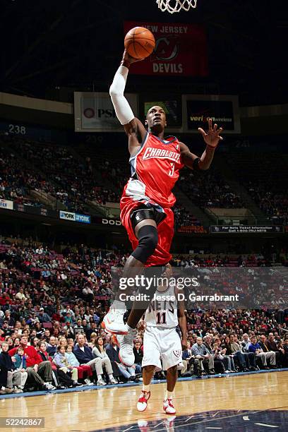 Gerald Wallace of the Charlotte Bobcats drives to the basket as Jacque Vaughn of the New Jersey Nets watches on February 25, 2005 at the Continental...