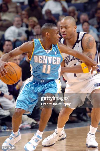 Earl Boykins of the Denver Nuggets handles the ball as Antonio Burks of the Memphis Grizzlies guards him at FedexForum on February 25, 2005 in...