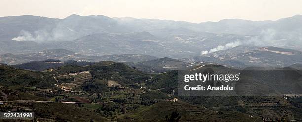 Photo taken from Yayladagi district of Turkey's Hatay province shows smoke rising after the Assad regime forces attacked at Syria's Mount Turkmen and...