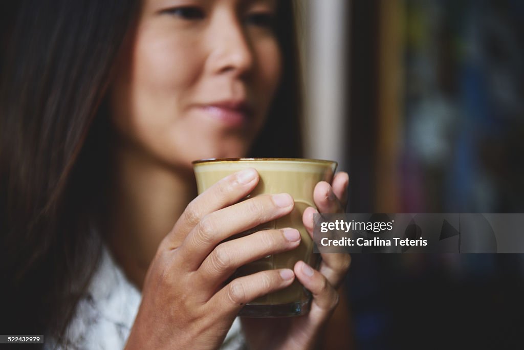 Woman holding cup of coffee