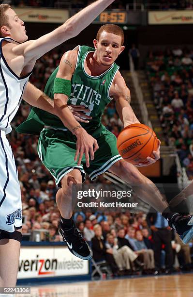 Delonte West of the Boston Celtics passes the ball against Curtis Bordchardt of the Utah Jazz on February 25, 2005 at the Delta Center in Salt Lake...