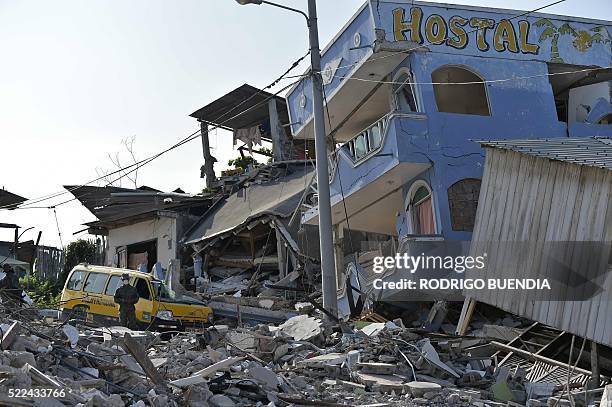 Soldier stands guard as rescuers search for victims in Pedernales, Ecuador on April 19, 2016. At least 413 people were killed when a powerful...