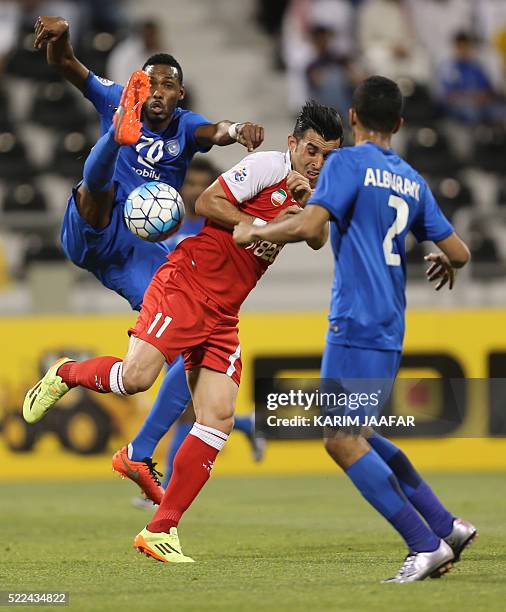 Tractorsazi Tabriz' Bakhtiar Rahmani vies for the ball with Al-Hilal's Mohammed al-Burayk and Mohammed Jahfali during their AFC Champions League...