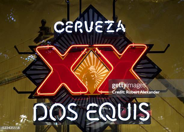 Dos Equis beer neon sign glows in a restaurant window on the Strip in Las Vegas, Nevada.