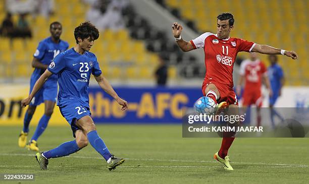 Tractorsazi Tabriz' Bakhtiar Rahmani vies for the ball with Al-Hilal's Kwak Taehwi during their AFC Champions League group stage football match in...