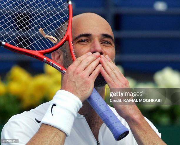 Andre Agassi of the US sends a kiss to the crowds after he won the match against Russia's Nikolay Davydenko during their quarter-final ATP Tennis...