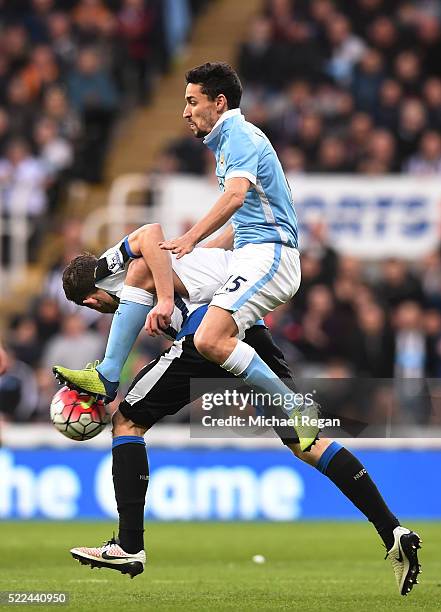 Paul Dummett of Newcastle United and Jesus Navas of Manchester City commpete for the ball during the Barclays Premier League match between Newcastle...