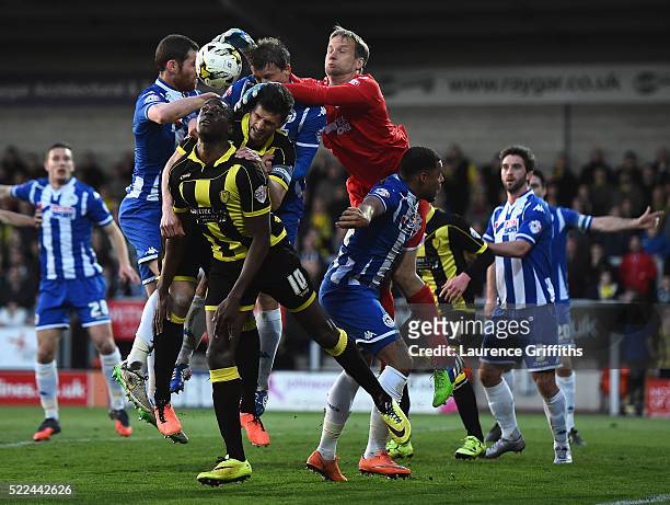Jussi Jaaskelainen of Wigan punches clear from Lucas Akins of Burton Albion during the Sky Bet League One match between Burton Albion and Wigan...