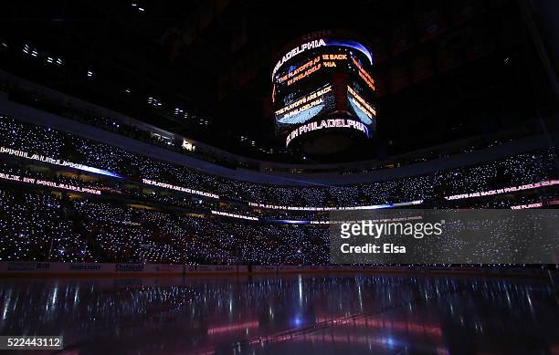 Fans participate in the pregame show with lighted wristbands before the game between the Philadelphia Flyers and the Washington Capitals in Game...