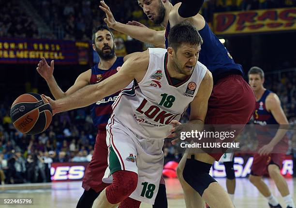 Barcelona's Croatian center Ante Tomic and Barcelona's guard Juan Carlos Navarro vie with Lokomotiv's Russian guard Evgeny Voronov during the...