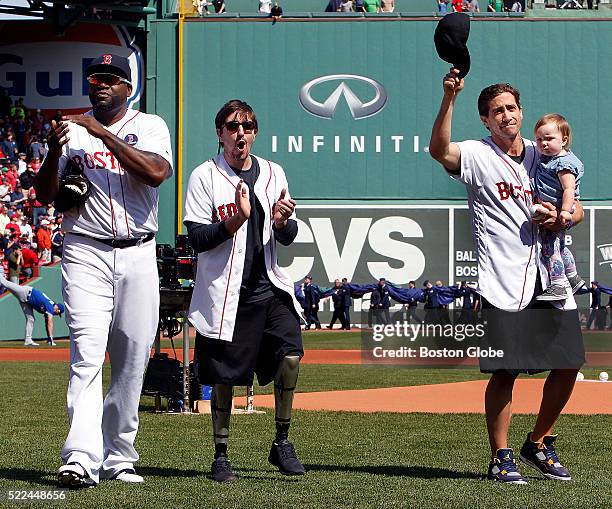 Boston Marathon bombing survivor Jeff Bauman, center, and the actor who is portraying him in the movie "Stronger" Jake Gyllenhaal, right, walk off...