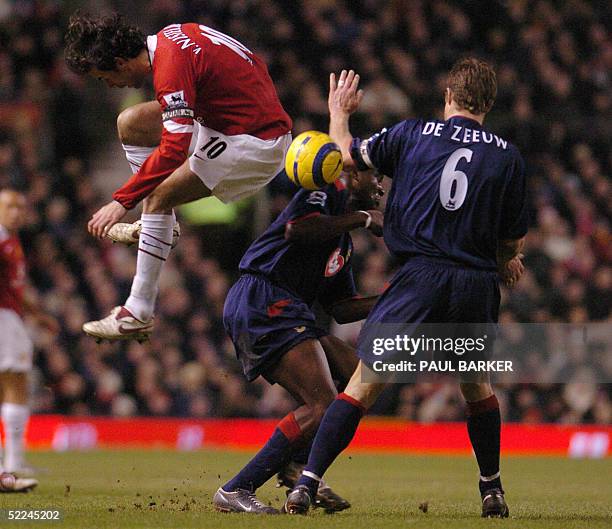Manchester United's Ruud Van Nistelrooy and Portsmouth's Valery Mezague and Arjan De Zeeuw vie in a Premiereship match at Old Trafford, Manchester,...