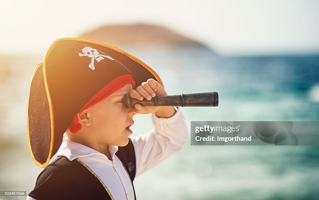 Little pirate looking with spyglass