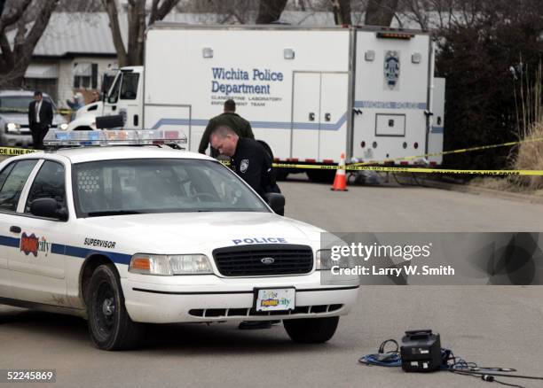 Police work in front of the house that Dennis Rader lives in February 26, 2005 in Park City, Kansas. Rader is the suspect whom police have arrested...