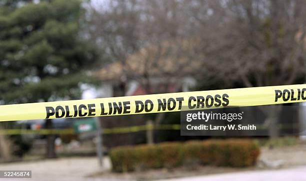 Police tape hangs across the street in front of the house that Dennis Rader lives in February 26, 2005 in Park City, Kansas. Rader is the suspect...