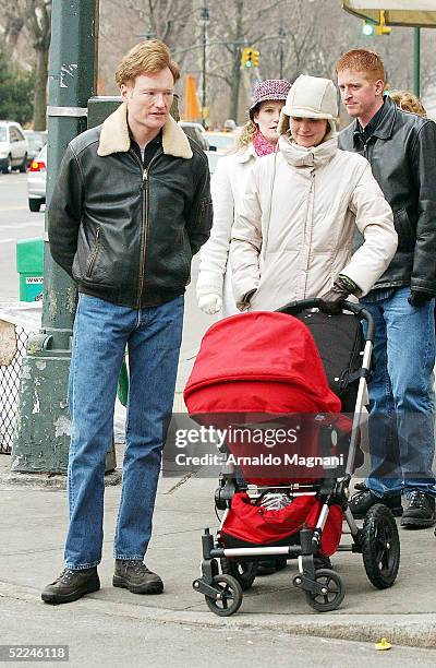 Talk show host Conan O'Brien and wife Liza Powell walk their daughter Neve along Central Park west on February 26, 2005 in New York City.