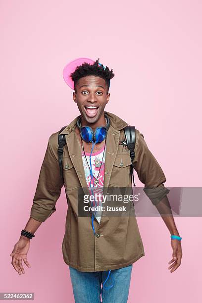 studio portrait of funky, excited afro american young man - happy man pink background stock pictures, royalty-free photos & images