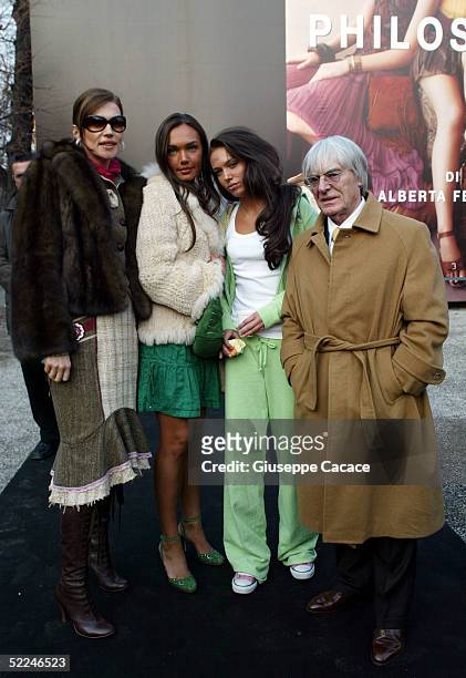 Bernie Ecclestone with his daughters Petra and Tamara and his wife Slavica pose at the entrance of the Philosophy By Alberta Ferretti fashion show as...