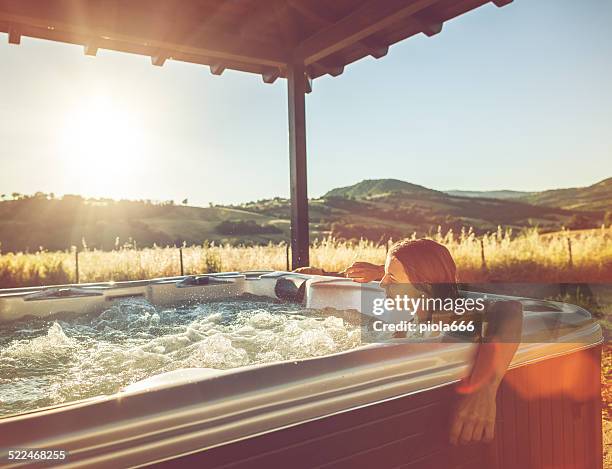 mulher com banheira de hidromassagem - hot tub - fotografias e filmes do acervo