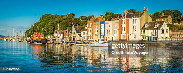 colourful fishing village homes on tranquil summer harbour weymouth dorset - weymouth stock pictures, royalty-free photos & images