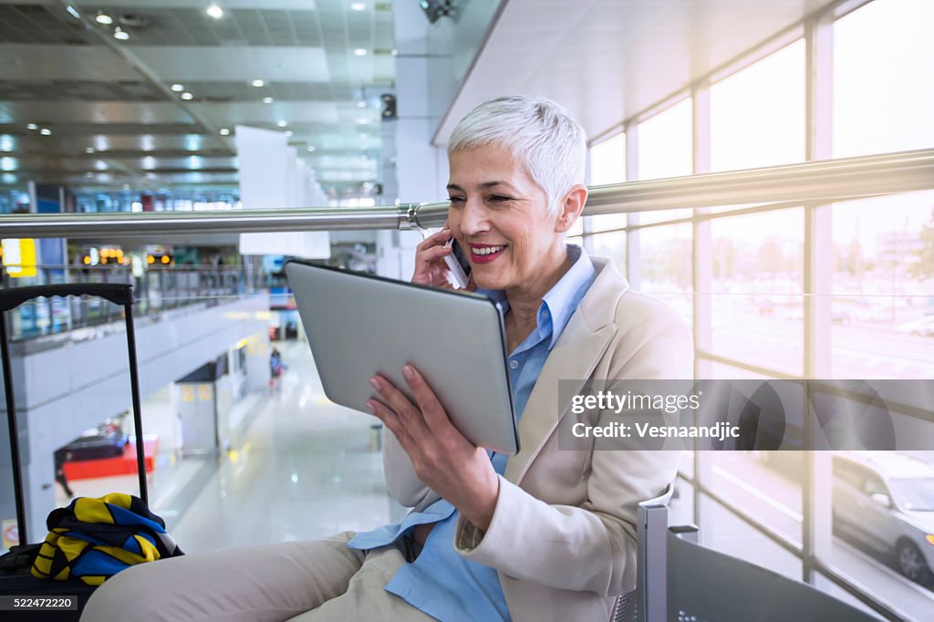 Business woman waiting for her flight in airport lounge