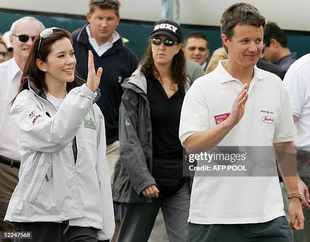 Crown Prince Frederik of Denmark, right, and his Australian wife, Princess Mary wave as they arrive at the docks for a yacht race against each other...