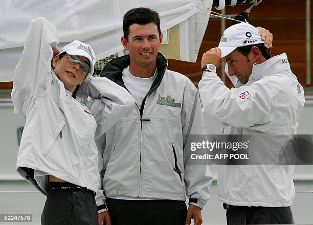 Crown Prince Frederik of Denmark's Australian wife, Princess Mary , adjusts her hat as she stands with fellow unidentified crewman before she...