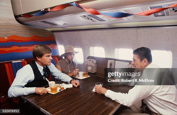 American politian and US President Ronald Reagan talking to one of his aides on board Air Force One, during his re-election campaign, Texas, June 1,...