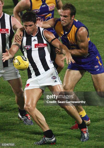 Brodie Holland for Collingwood and Chris Judd for West Coast in action during the AFL Wizard Cup quarter finals between Collingwood Magpies and West...