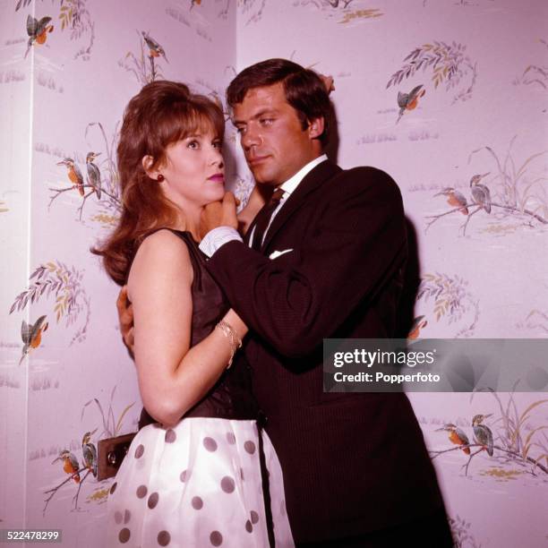 English actors Oliver Reed and Jane Merrow pictured together in a scene from the film 'The Girl-Getters' aka 'The System' in August-September 1963.